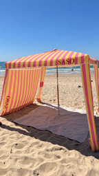 Pink and yellow SASO beach cabana with shade wall attached
